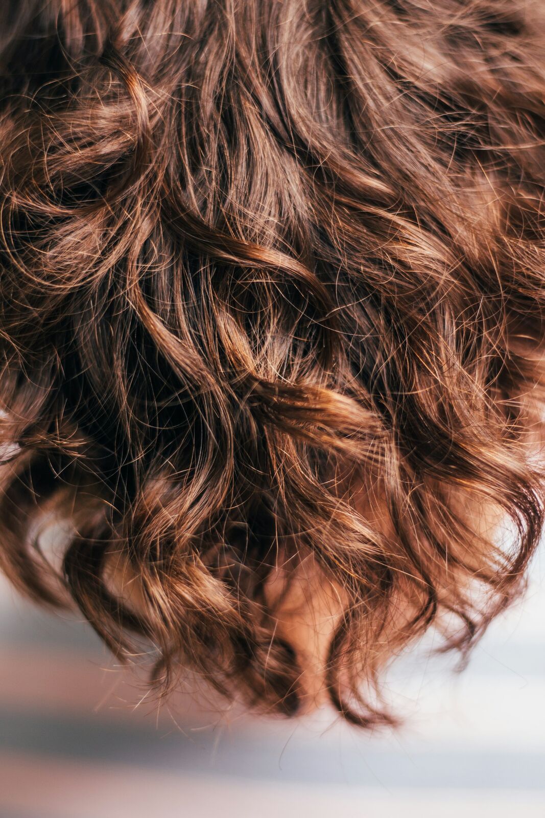 Glossy brown waves of hair, close up